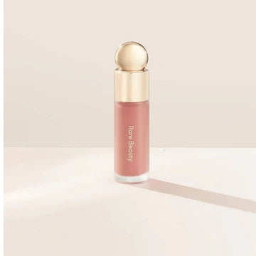Close-up of dewy and matte liquid blush tubes lined up in a flat lay