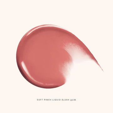  Model applying blush to cheeks with fingertips for natural glow