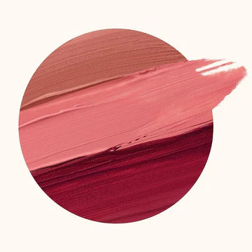Flat-lay of the eyeshadow tube beside matching blush and lip balm for a coordinated look.

