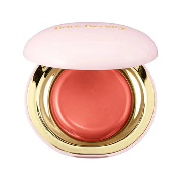 Compact blush in open view with creamy dome-like surface

