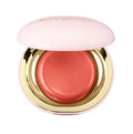 Compact blush in open view with creamy dome-like surface


