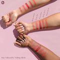 Model applying blush with fingertips for a natural look

