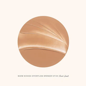 Hand blending cream bronzer with a brush for a soft, sculpted effect

