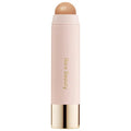 Hand blending cream bronzer with a brush for a soft, sculpted effect

