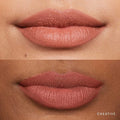 Model applying soft matte lipstick with a smooth, even finish on her lips.

