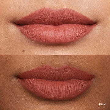 Close-up of lips wearing a bold soft matte lipstick shade with a smooth finish.

