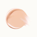 Model applying concealer under eyes with a seamless, radiant finish.

