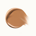 Flat-lay of multiple concealer shades arranged in a gradient, showing variety for all skin tones.


