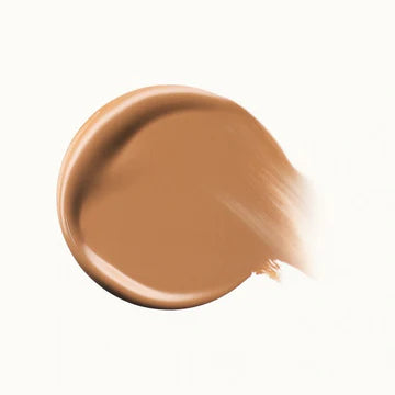 Flat-lay of multiple concealer shades arranged in a gradient, showing variety for all skin tones.

