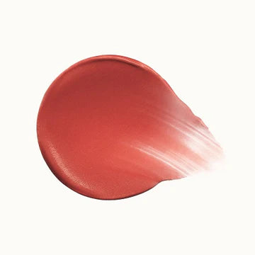 Minimalist flat-lay of blush tubes with open applicators and color dabs.

