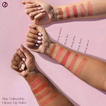 Glossy swatches of lip gloss shades on skin tones ranging from light to deep.

