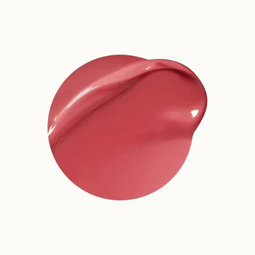 Model applying lip gloss, showcasing a smooth and shiny finish.

