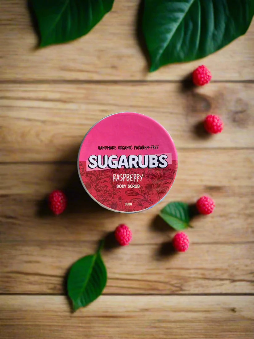 Close-up of the raspberry scrub texture on a wooden spatula, highlighting its smooth and rich consistency.