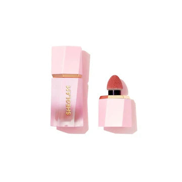 SHEGLAM Color Bloom Dayglow Liquid Blush in 'Rose Ritual,' housed in a sleek, matte-finish tube with bold white typography reading '4 DIFFERENT WAYS TO BLUSH.' The compact design features a precision doe-foot applicator for controlled application, ideal for on-the-go touch-ups