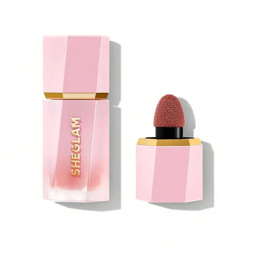 Close-up of SHEGLAM's upgraded liquid blush packaging in shade 'Cutie Pie,' featuring a leak-proof bottle with redesigned cap and sponge-tip applicator. The text 'SAY GOODBYE TO LEAKS & SPILLS!' prominently displayed, highlighting consumer-tested improvements. The compact, square-shaped bottle has a matte finish with shade name clearly labeled
