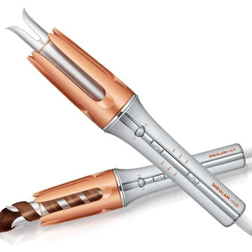 Front view of SHEGLAM It-Curl One-Touch Instant Curler showing its sleek, modern design with matte finish body, digital temperature display, and ergonomic handle. The curling barrel features a glossy ceramic coating, with clearly marked directional buttons (left/right curl) and anti-tangle grooves visible along the barrel length