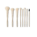 Flat lay demonstration of all 8 SHEGLAM Pro Core makeup brushes arranged in a circle, showcasing each brush type with labels: (1) Powder Brush – domed fluffy head, (2) Foundation Brush – dense flat shape, (3) Blush Brush – angled contour, (4) Eyeshadow Brush – tapered blending, (5) Small Shader Brush – compact oval, (6) Flame Brush – pointed tip, (7) Concealer Brush – short dense bristles, and (8) Eyebrow & Mascara Brush – dual-ended with spoolie. All feature matching beige handles and synthetic bristles
