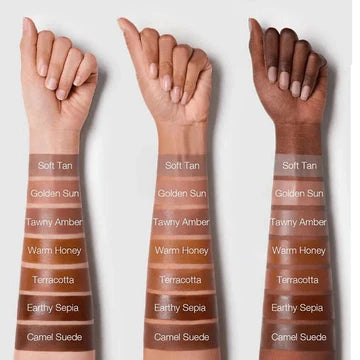 Swatches of SHEGLAM Sun Sculpt Liquid Contour in seven shades (Soft Tan, Golden Sun, Ravity Amber, Warm Honey, Tetraextra, Equity Sepia, Camel Suede) displayed in rows on a neutral background. Each shade shows a warm-toned, highly pigmented liquid contour formula, ranging from light tan to deep amber, suitable for various skin tones