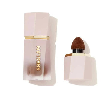 SHEGLAM Sun Sculpt Liquid Contour packaging featuring a slim, rectangular glass bottle with a matte black pump dispenser. The front label displays the product name in gold lettering against a warm beige background, with 'Earthy Sepia' shade clearly marked. The minimalist design highlights the luxury aesthetic with clean typography and brand logo prominently visible