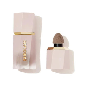 Front and side view of SHEGLAM Sun Sculpt Liquid Contour packaging, showing a sleek, tube-style bottle with a matte finish and gold accent details. The product label clearly displays 'Sun Sculpt Liquid Contour' in bold typography, along with shade name and brand logo. The twist-up design and precision applicator tip are visible
