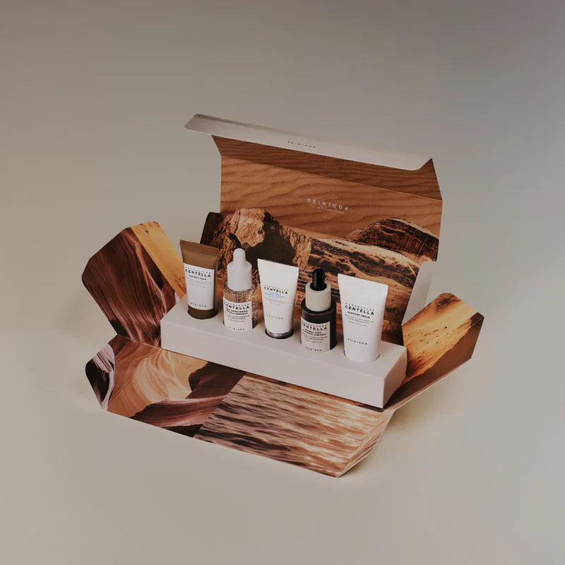 Skincare product set with bottles and cream in a wooden display box, featuring the brand 'Skin1004'.