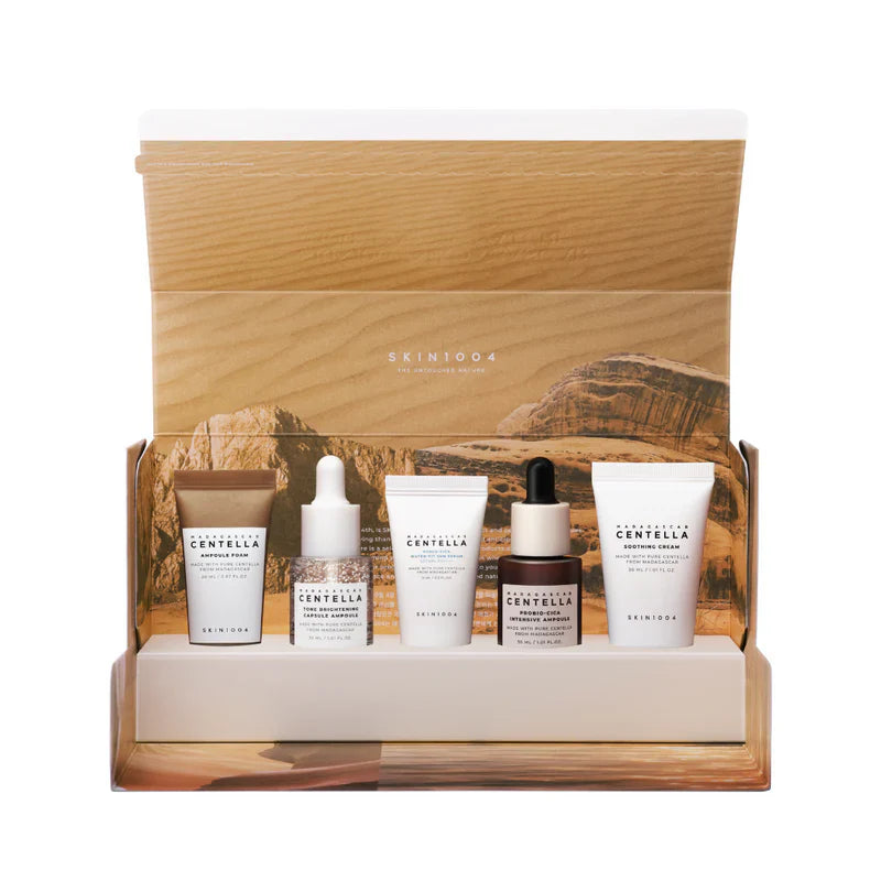 Skincare product set with bottles and cream in a wooden display box, featuring the brand 'Skin1004'.