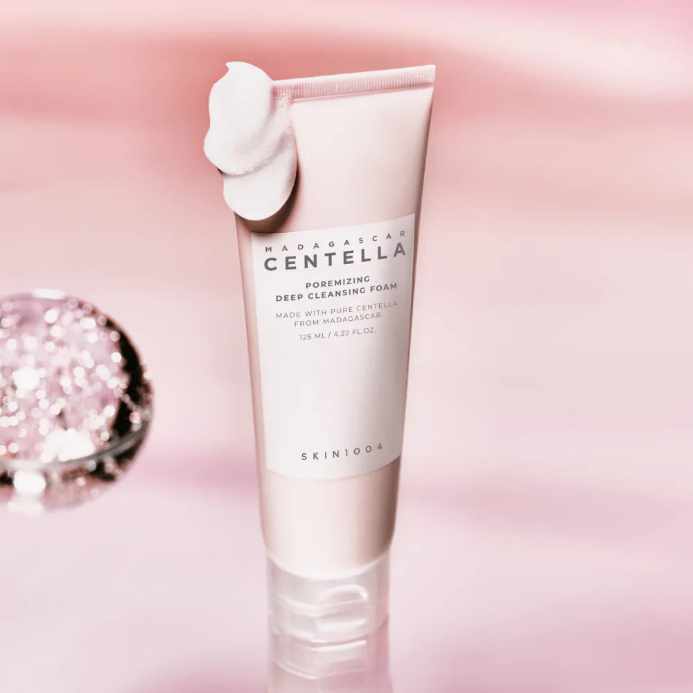 Pink tube of cleansing foam with text on a white background