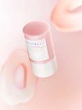 Skincare stick with a label on a soft pink background