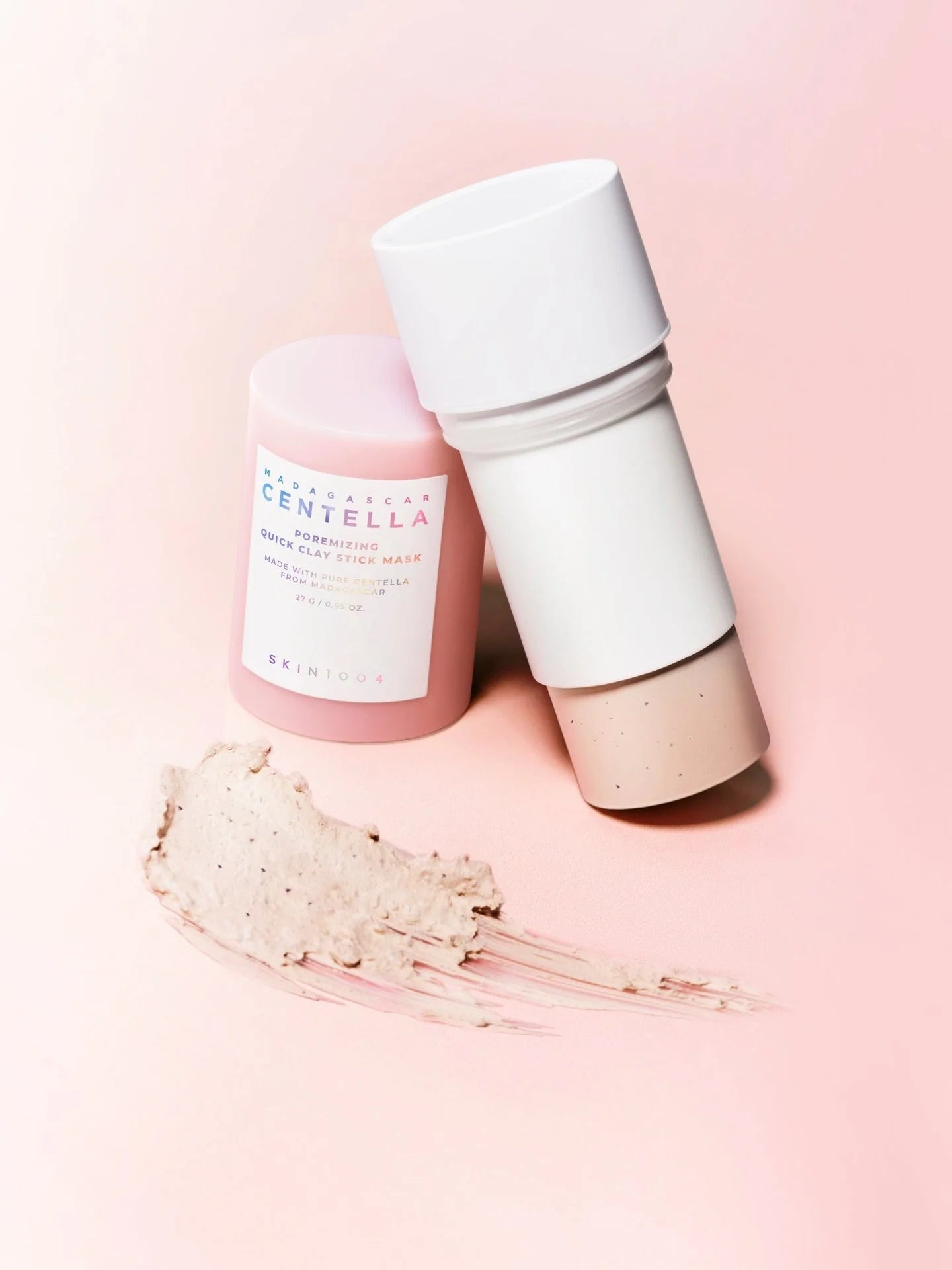 Two skincare products on a pink background