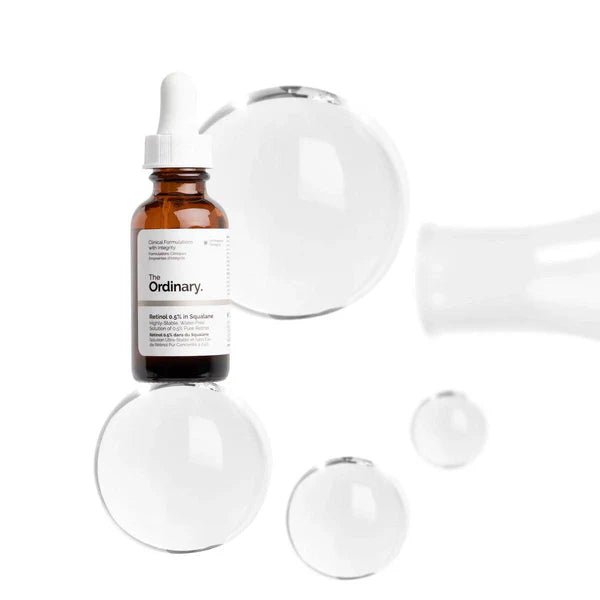 "Clear serum drop being applied to skin with dropper"

